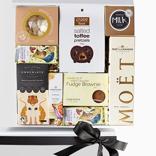 A celebratory gift box with gourmet food and alcohol