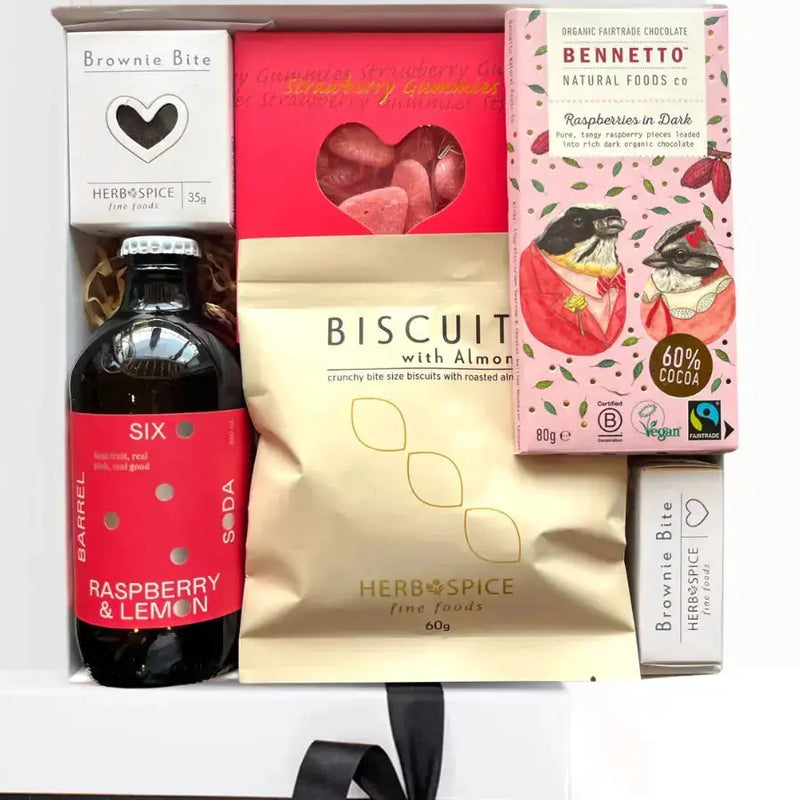 Assorted food items including a bottle, boxes, and a bag on a white background