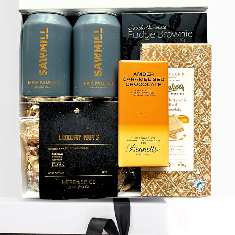 Gift set with Sawmill India Pale Ale, chocolate, and nuts on a white background