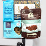 Assorted New Zealand chocolate and snack packages on a white background