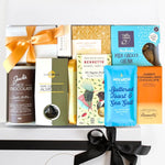 Assorted chocolate products including a jar of hot chocolate, a box of dark chocolate almonds, and various chocolate bars with visible branding.