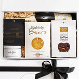 Gift box with snacks and a bottle of wine on a white background