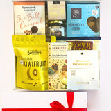 Assorted gourmet food items in a box with visible brands and packaging.
