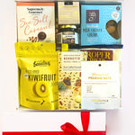 Assorted gourmet food items in a box with visible brands and packaging.