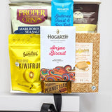 Assorted snack items including crisps, chocolate bars, and cookies on a white background
