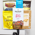 Assorted snack items including crisps, chocolate bars, and cookies on a white background