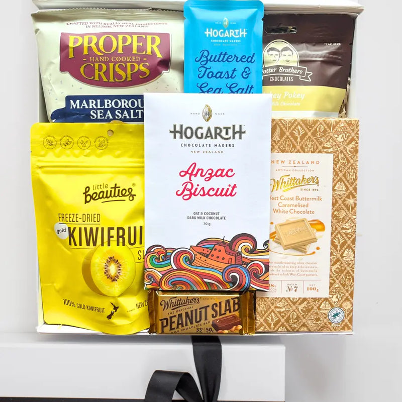 Assorted snack items including crisps, chocolate bars, and cookies on a white background
