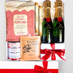 Gift set with Moët champagne, popcorn, and festive spice mix on a white background