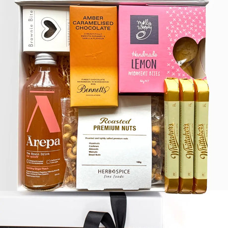 Gift set with drinks, snacks, and confectionery on a white background