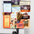 Assorted snack packages including biscuits, popcorn, and ginger fingers on a white background