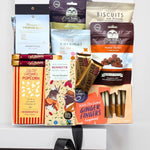 Assorted snack packages including biscuits, popcorn, and ginger fingers on a white background