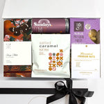 Gift box with various snack packs including 'Sundays' and 'Handmade Passion Fruit'.