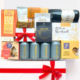 Gift basket with wine, snacks, and beer cans on a white background
