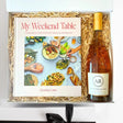 Gift set with a cookbook and a bottle of wine in a box.