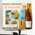 Gift box with a cookbook, wine, and other items on a white background