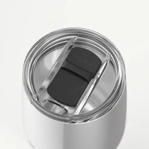 Silver tumbler with a black lid on a white background